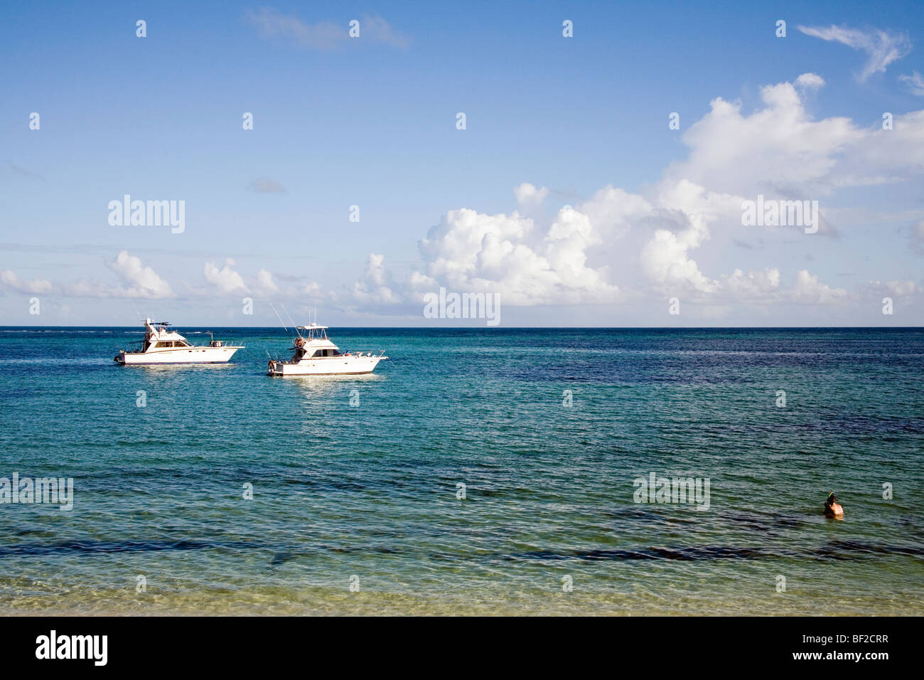 Fishing boats along reef, Seychelles Stock Photo
