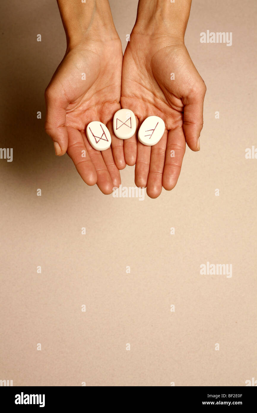 a women's hands holding the mystic nortic runes Stock Photo