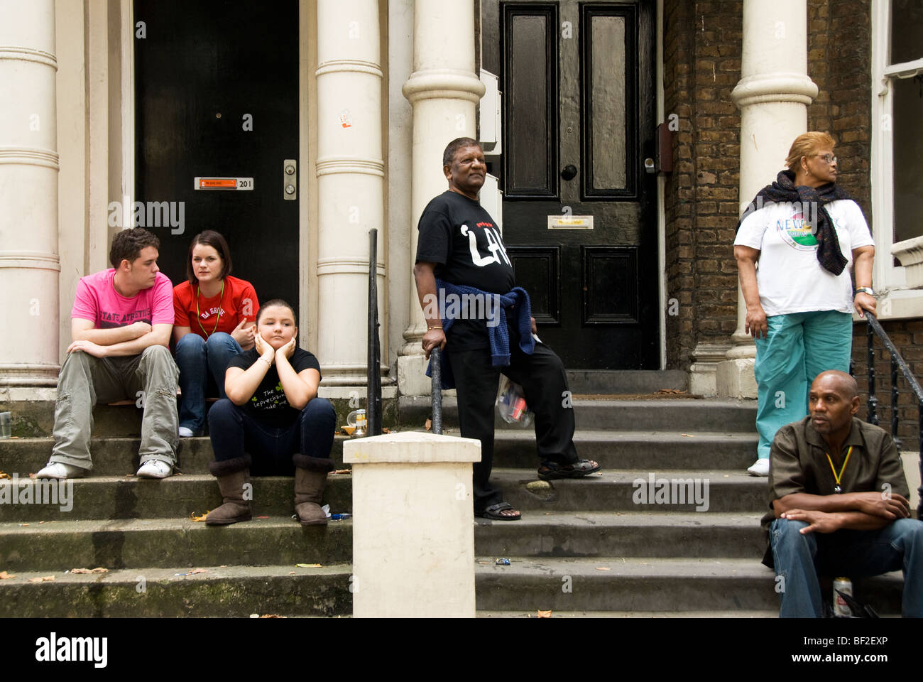 Group of family and friends on front doorstep in West London at Notting Hill carnival time Stock Photo