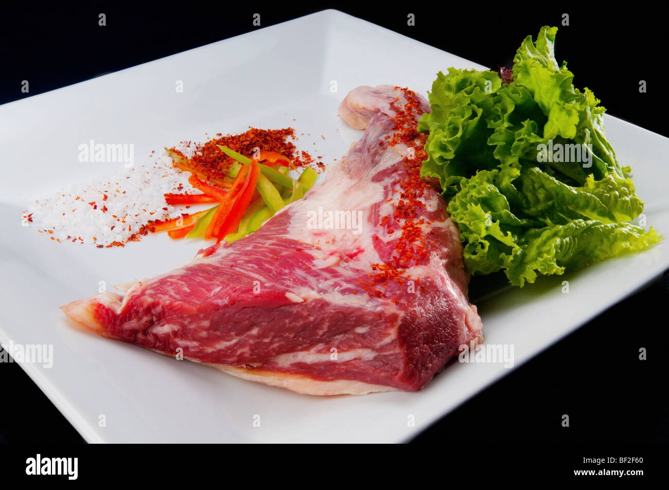 Close-up of a steak with ground red chilies and peppers Stock Photo
