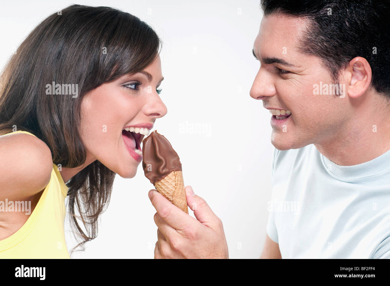 Couple sharing an ice cream cone Stock Photo