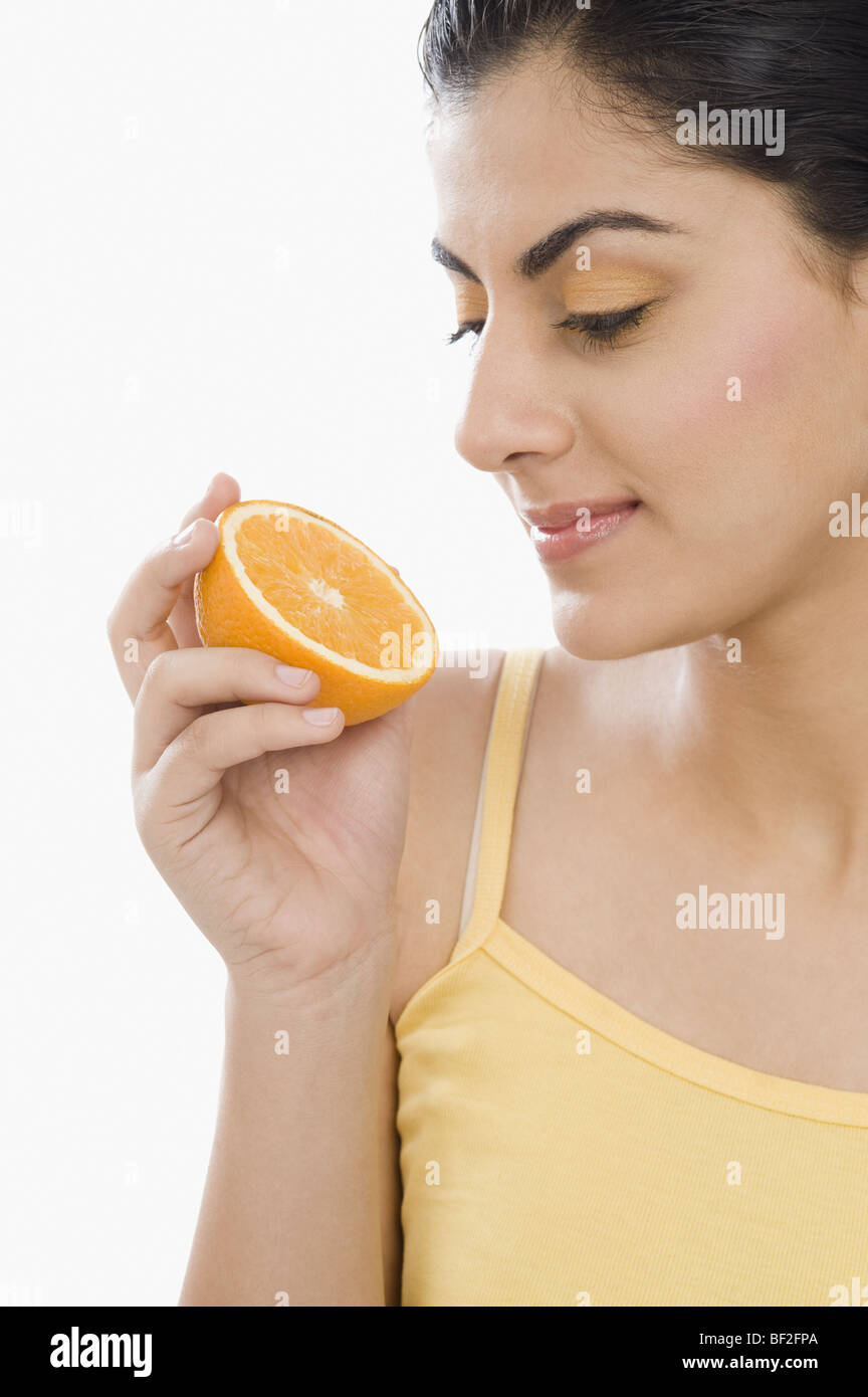 Human hand holding half orange hi-res stock photography and images - Alamy