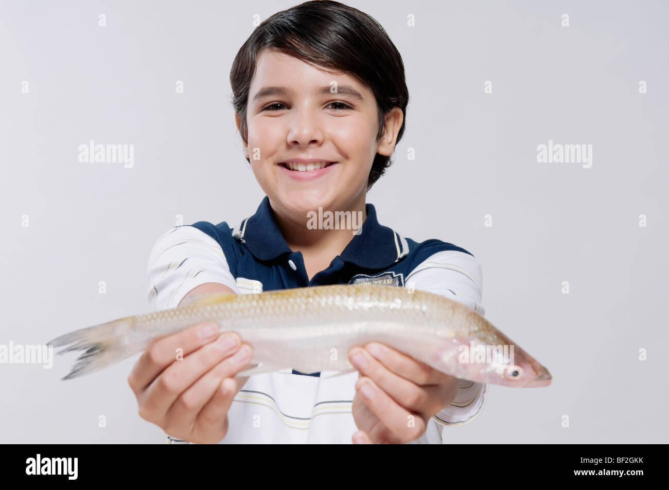 Boy holding a fish hi-res stock photography and images - Alamy