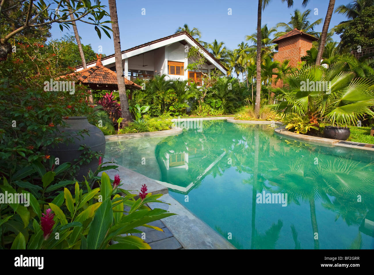 A luxury tropical modern villa with swimming pool surrounded by tropical gardens Stock Photo