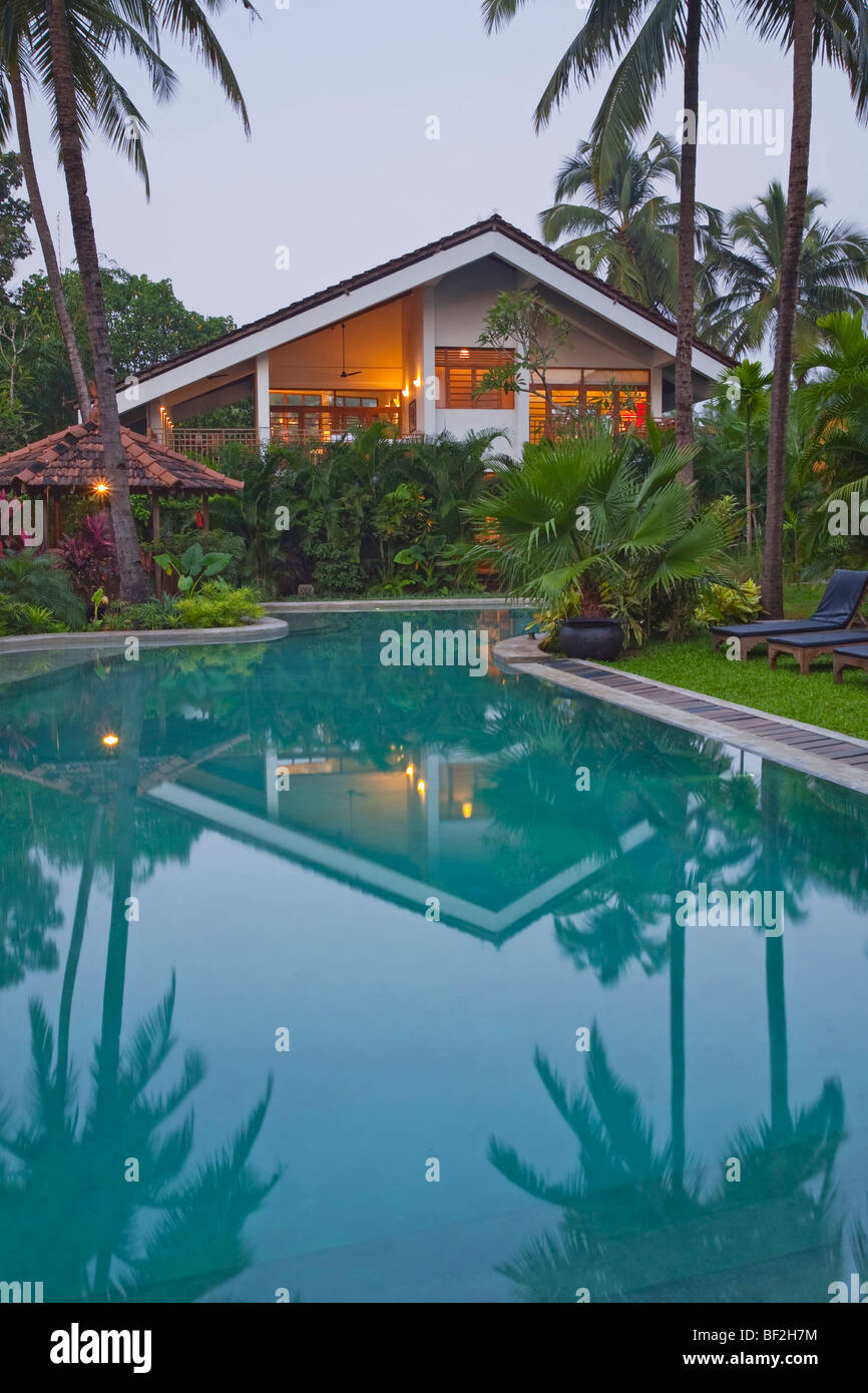 A luxury tropical modern villa with swimming pool surrounded by tropical gardens Stock Photo