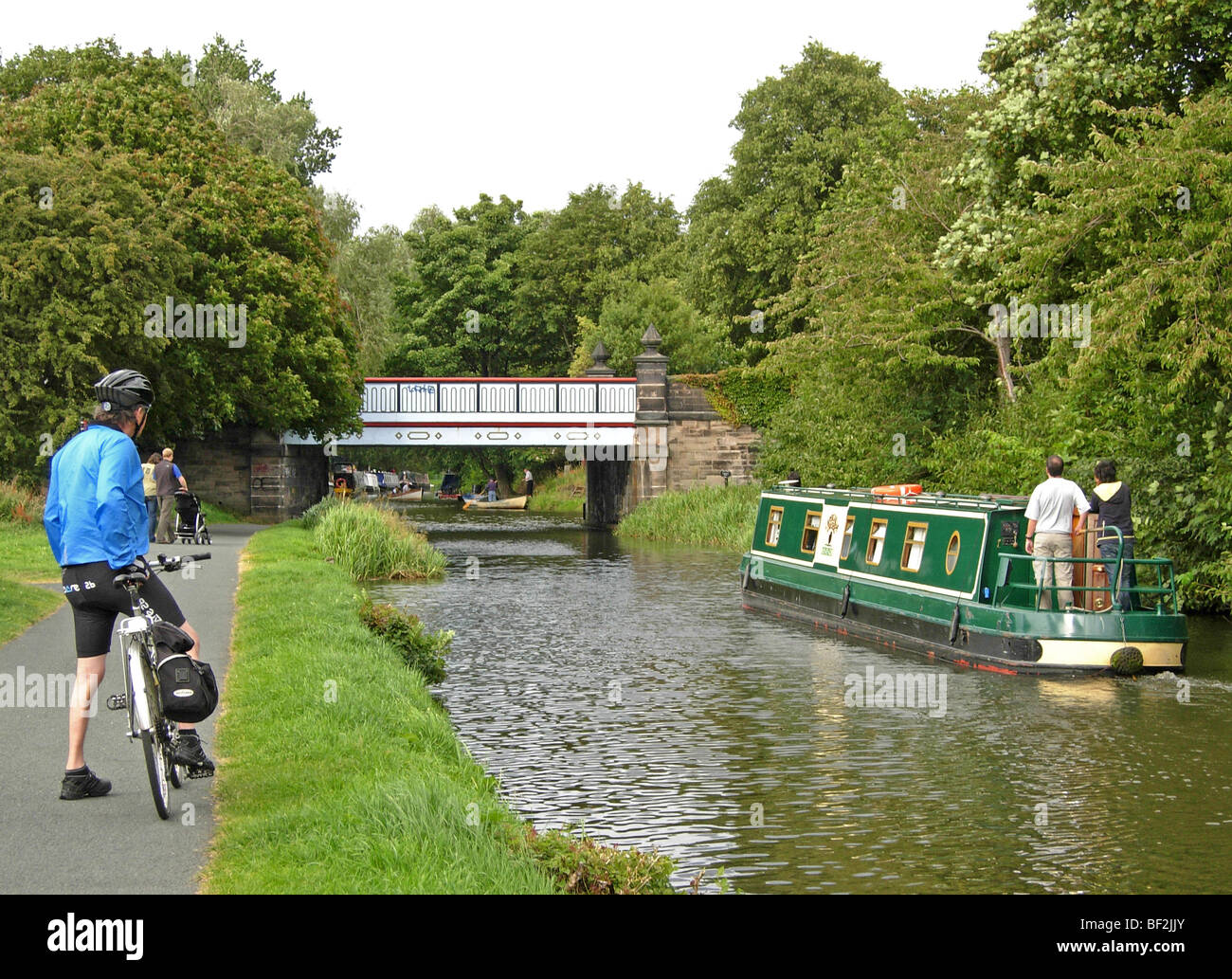 cyclist, walkers and canal boat on the Union Canal running through Edinburgh Stock Photo