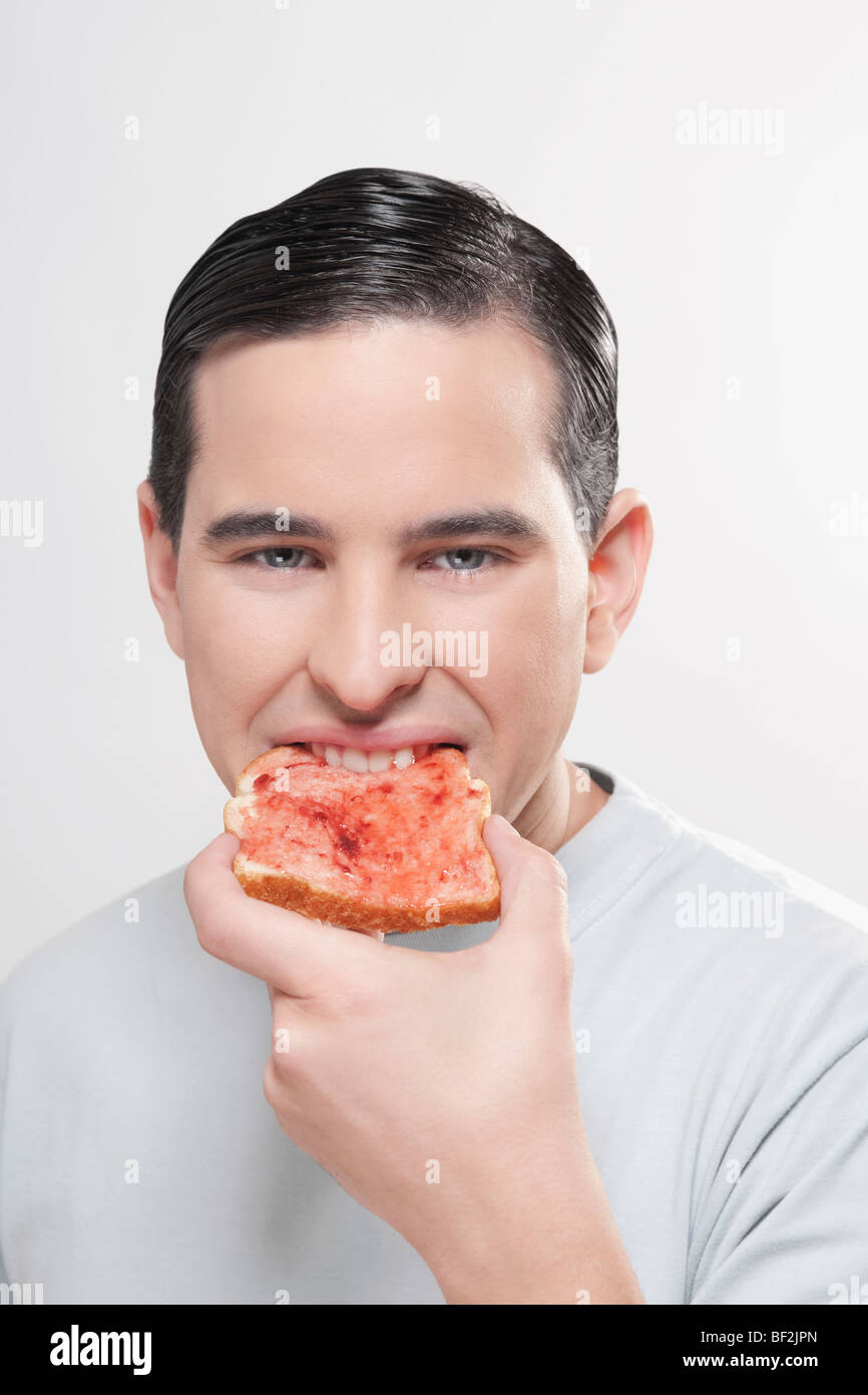 Man eating jam on toast Stock Photo Alamy