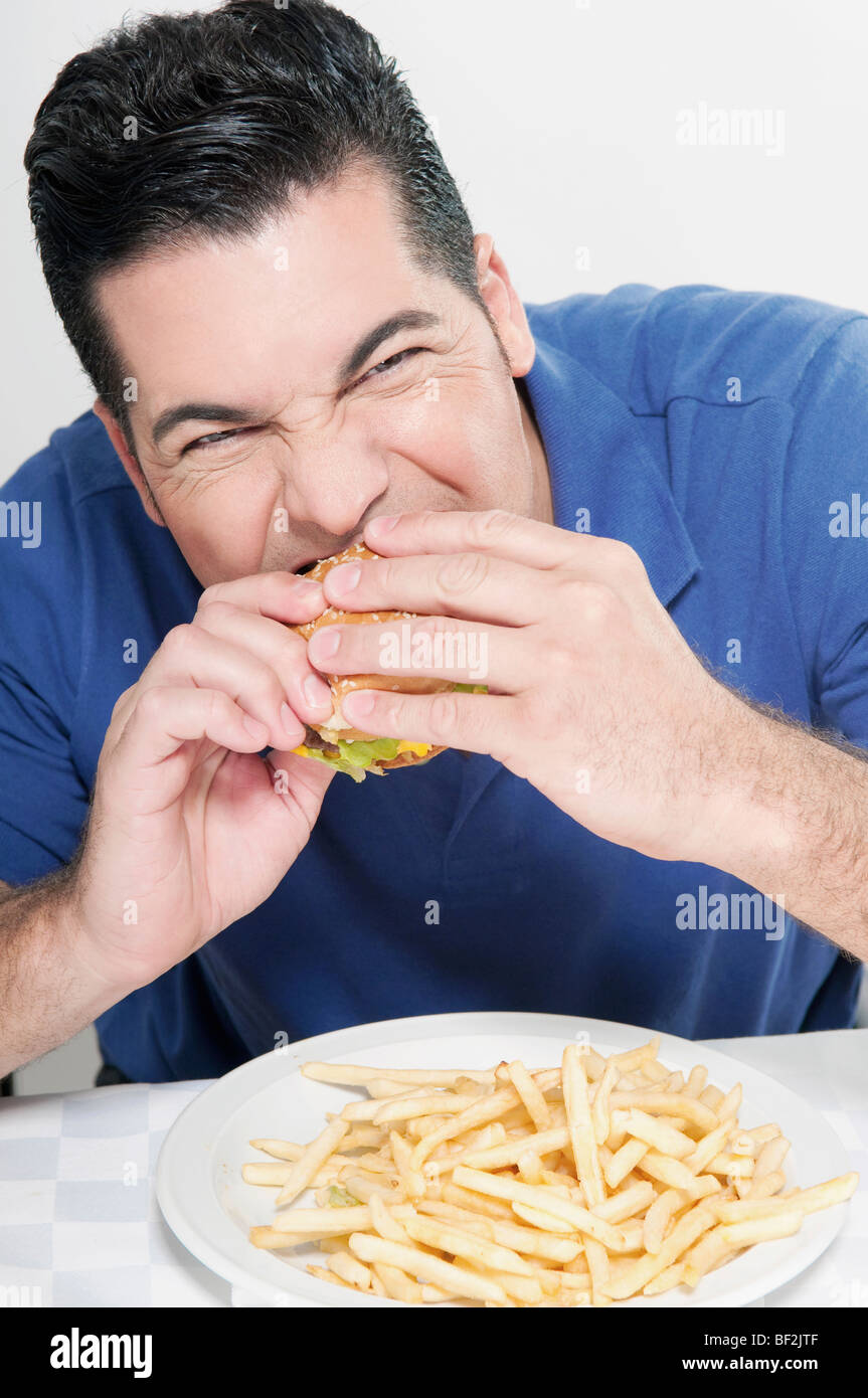 Man eating a hamburger Stock Photo