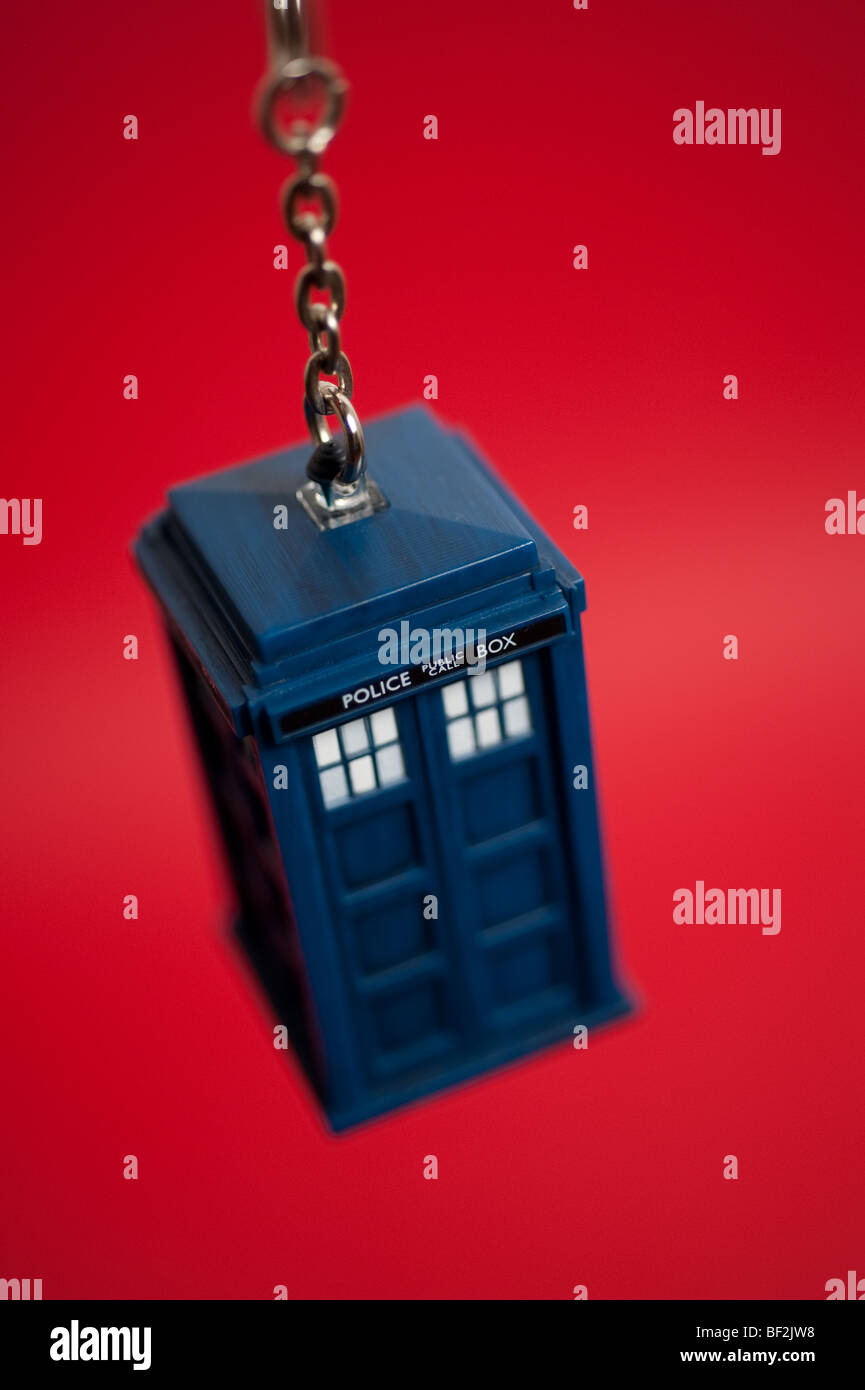 A Doctor Who Tardis keyring hangs in front of a background. Stock Photo