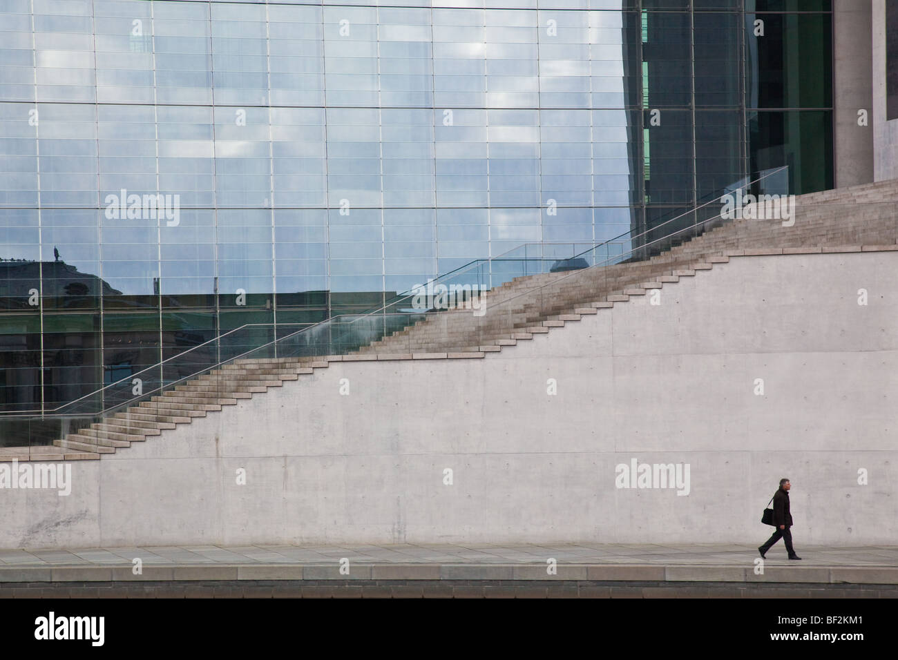 A man walking in front of the Marie-Elisabeth Luders Building by the banks of the River Spree in Berlin Stock Photo