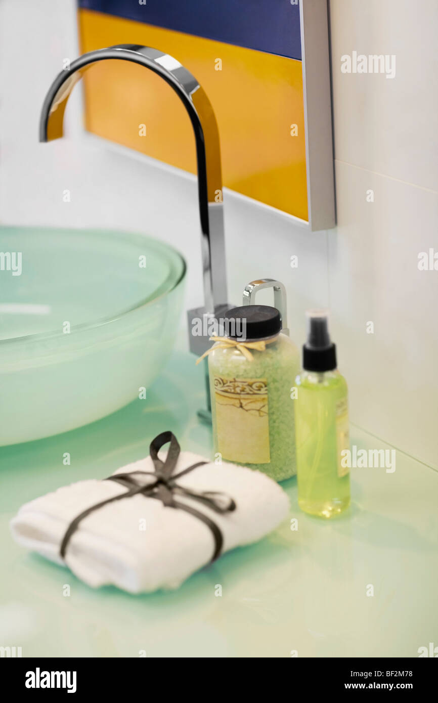 Bottle of shower gel and wicker basket with shells on sink in bathroom  Stock Photo - Alamy