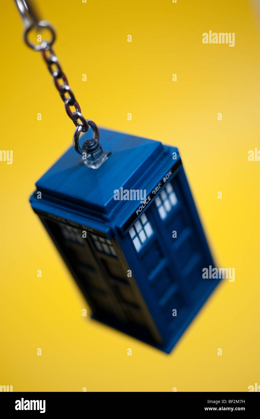 A Doctor Who Tardis keyring hangs in front of a background Stock
