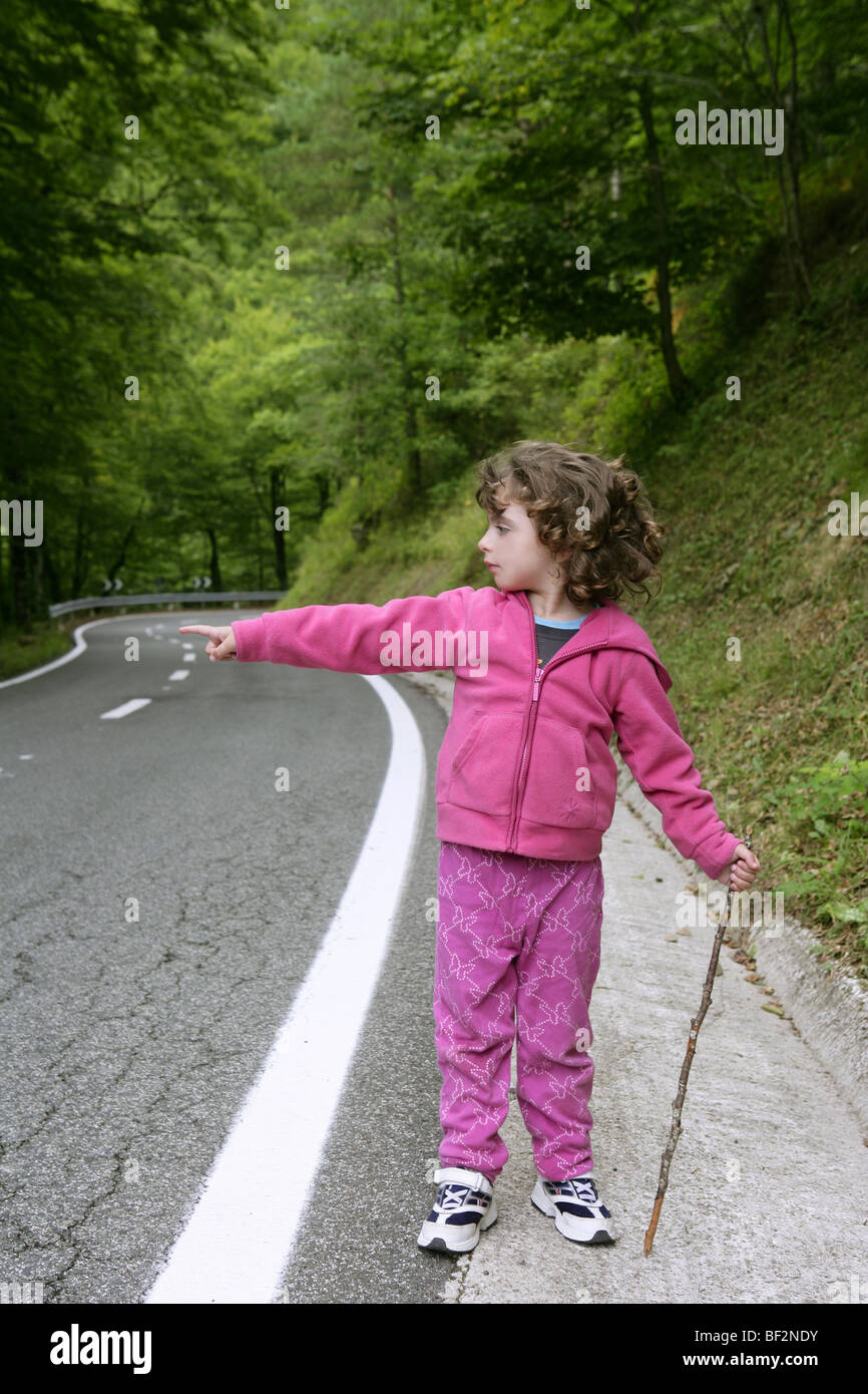 Cute little girl in a forest road dress in pink Stock Photo - Alamy