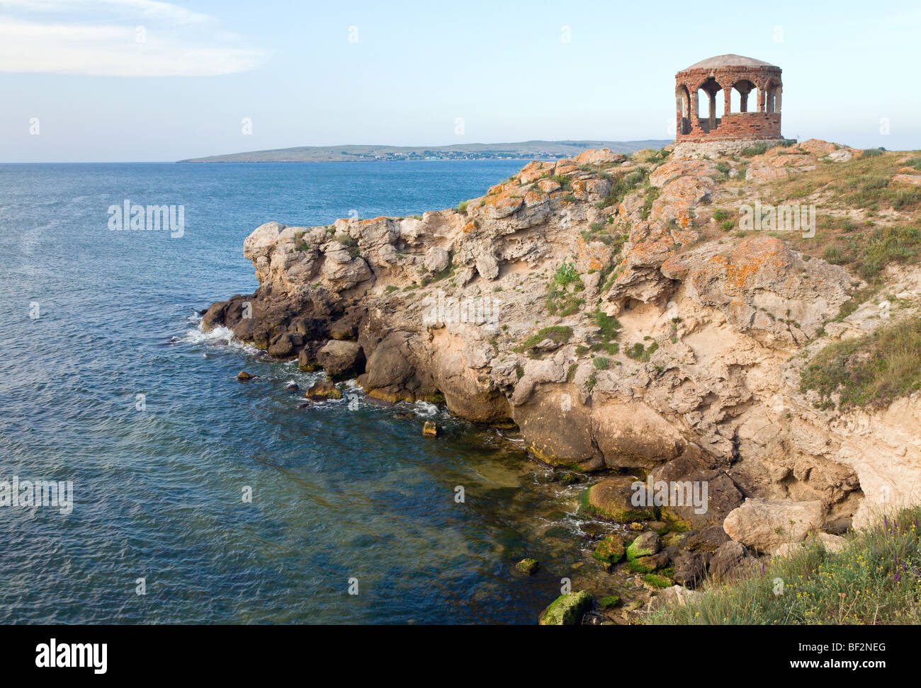 Rocky summer coastline and cape with pavilion Stock Photo - Alamy