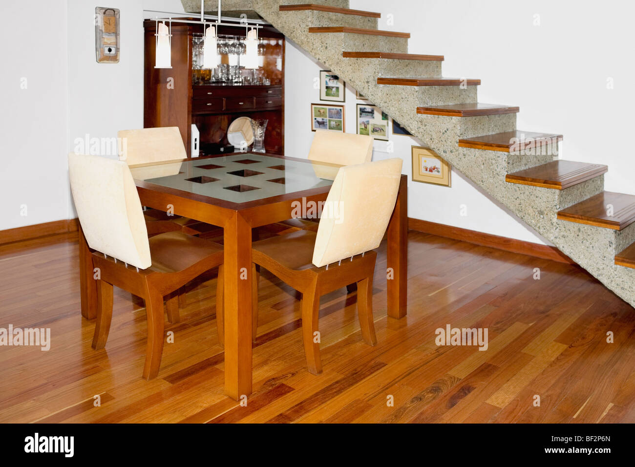 Dining table near a staircase Stock Photo Alamy