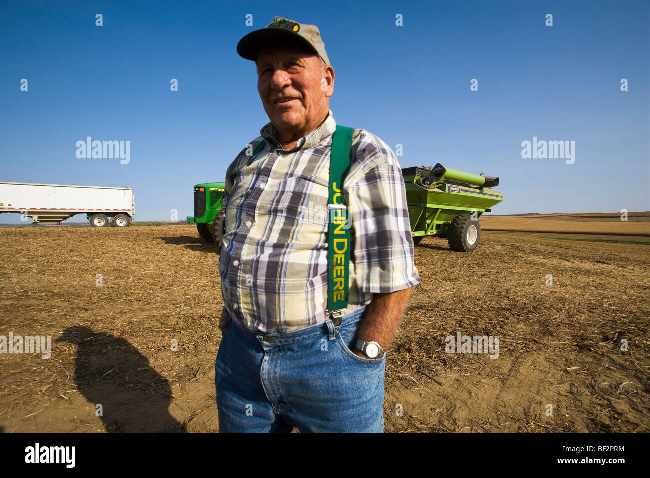 An elderly farmer observes the operations on the family farm during the