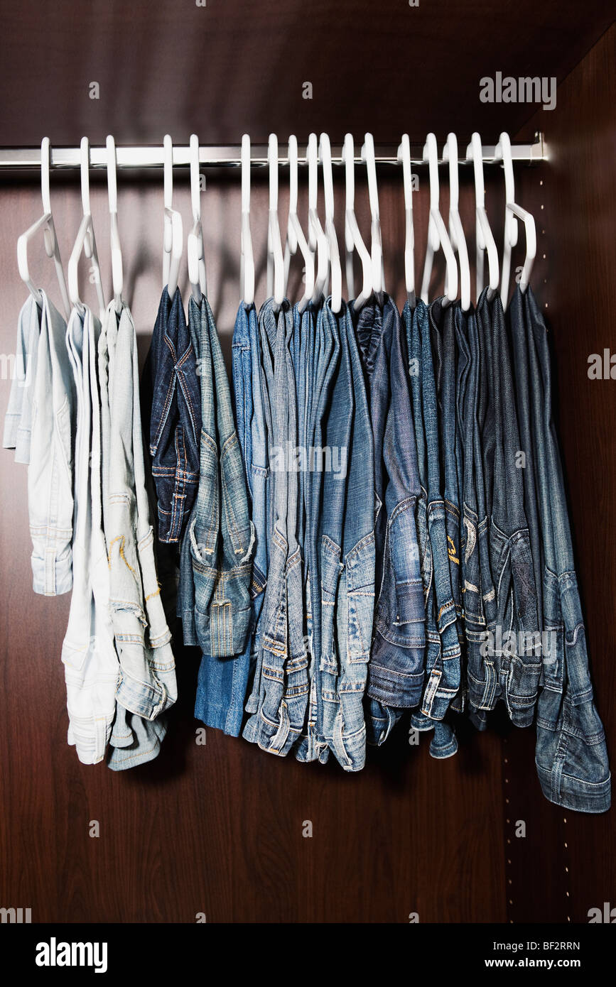 Clothes hanging in a closet Stock Photo Alamy