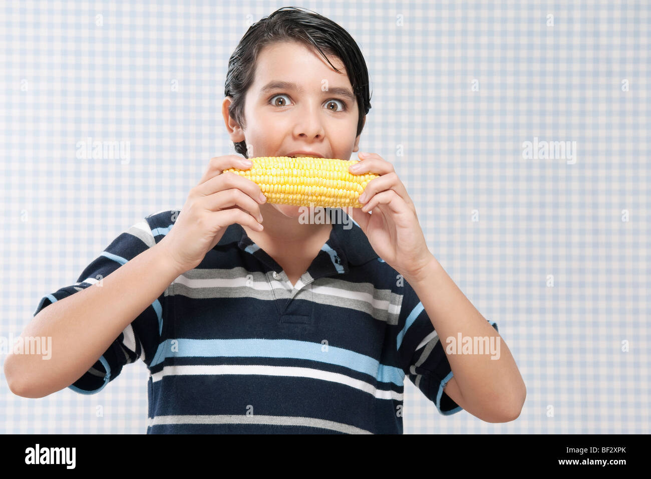 Boy eating corn on the cob Stock Photo