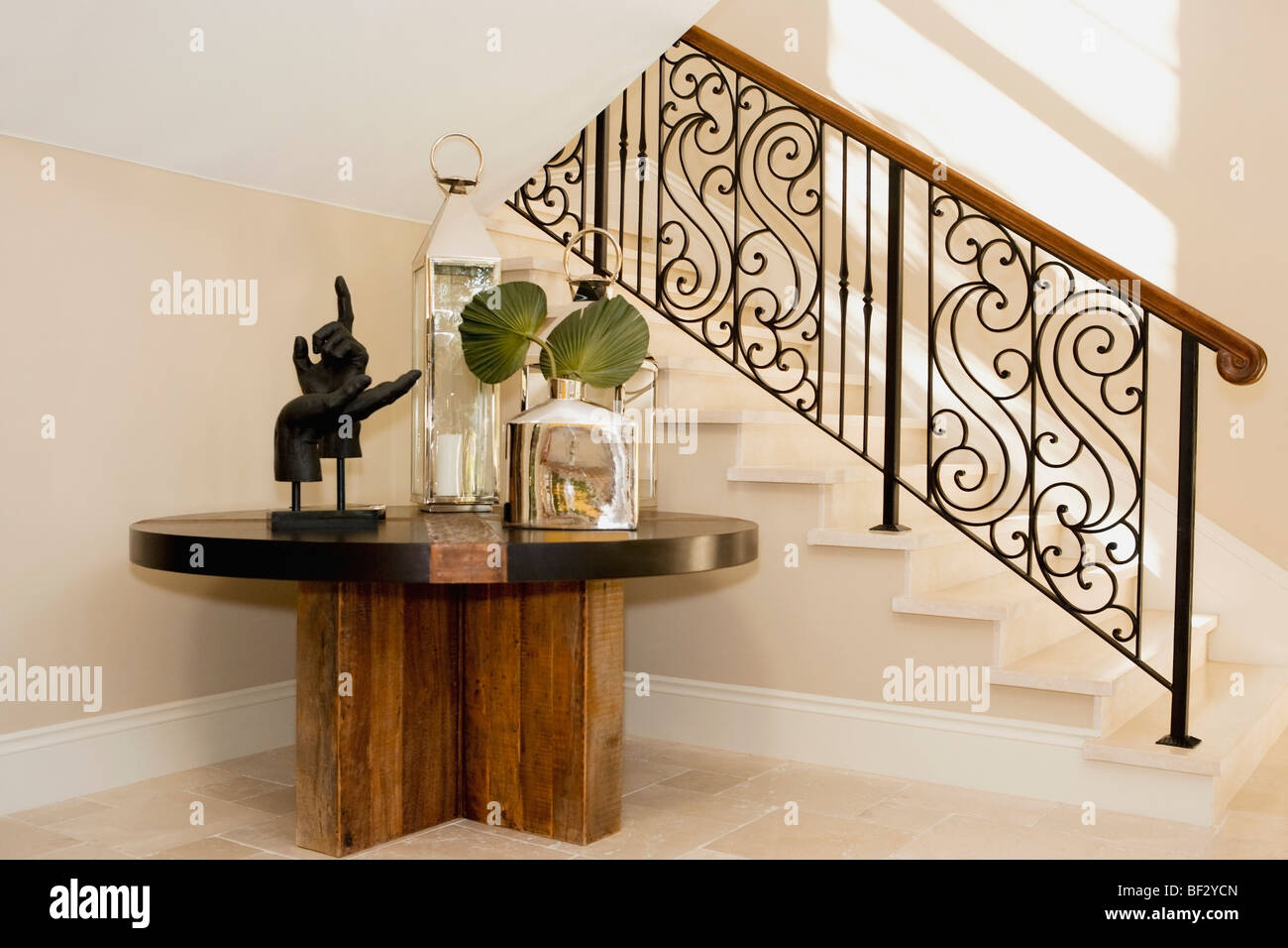 Show pieces on a table under a staircase Stock Photo - Alamy