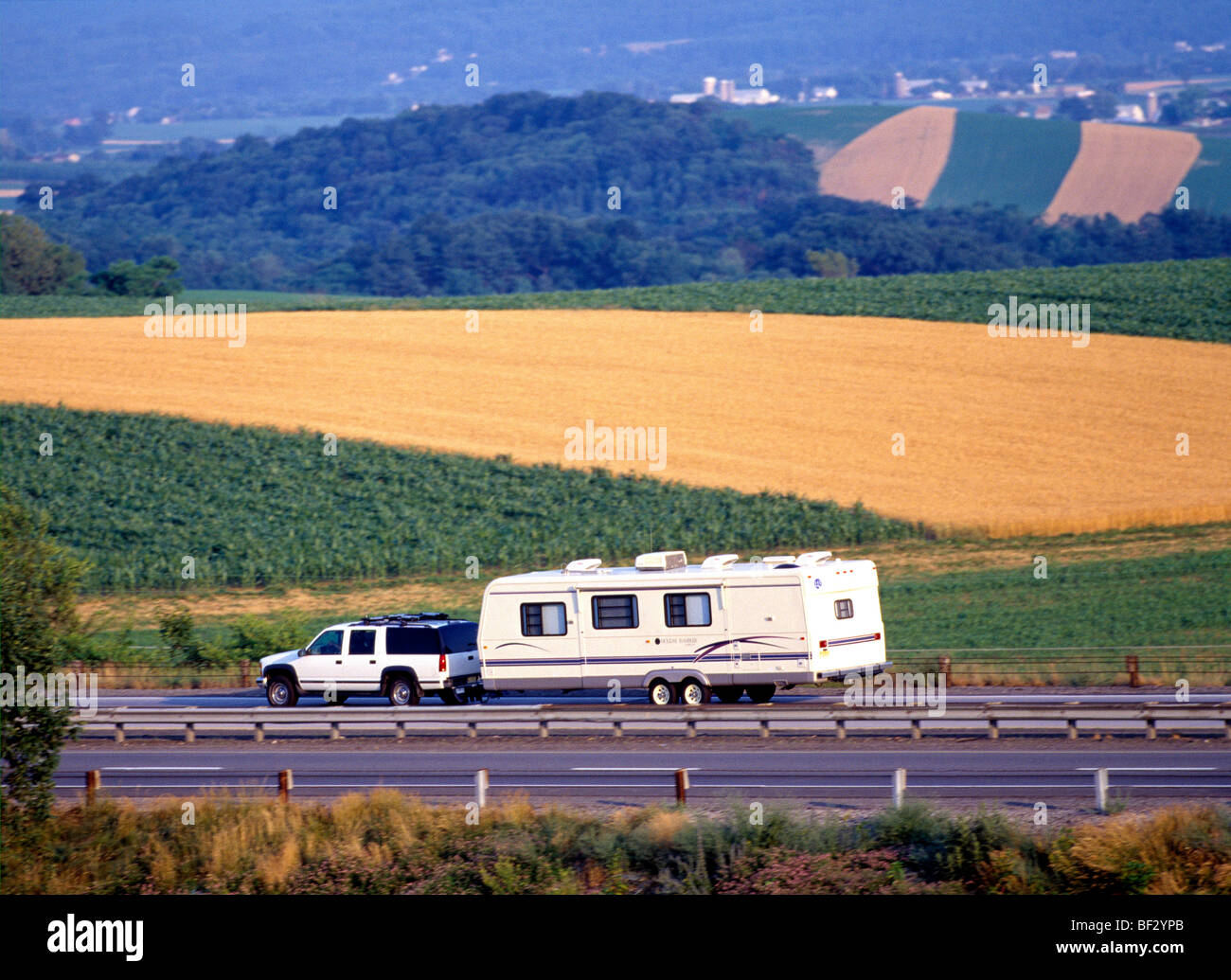 Chevy Suburban towing a trailer in Colorado on the Interstate Highway Stock Photo