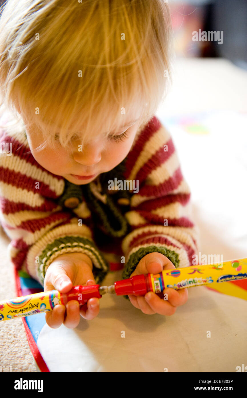 baby girl, toddler,2 ,  playing with drawing pens. Stock Photo