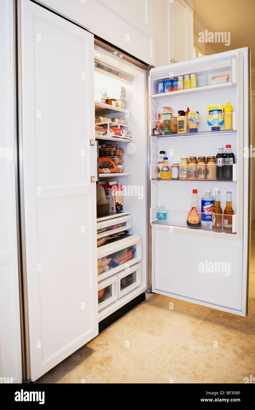 Open refrigerator in a kitchen Stock Photo