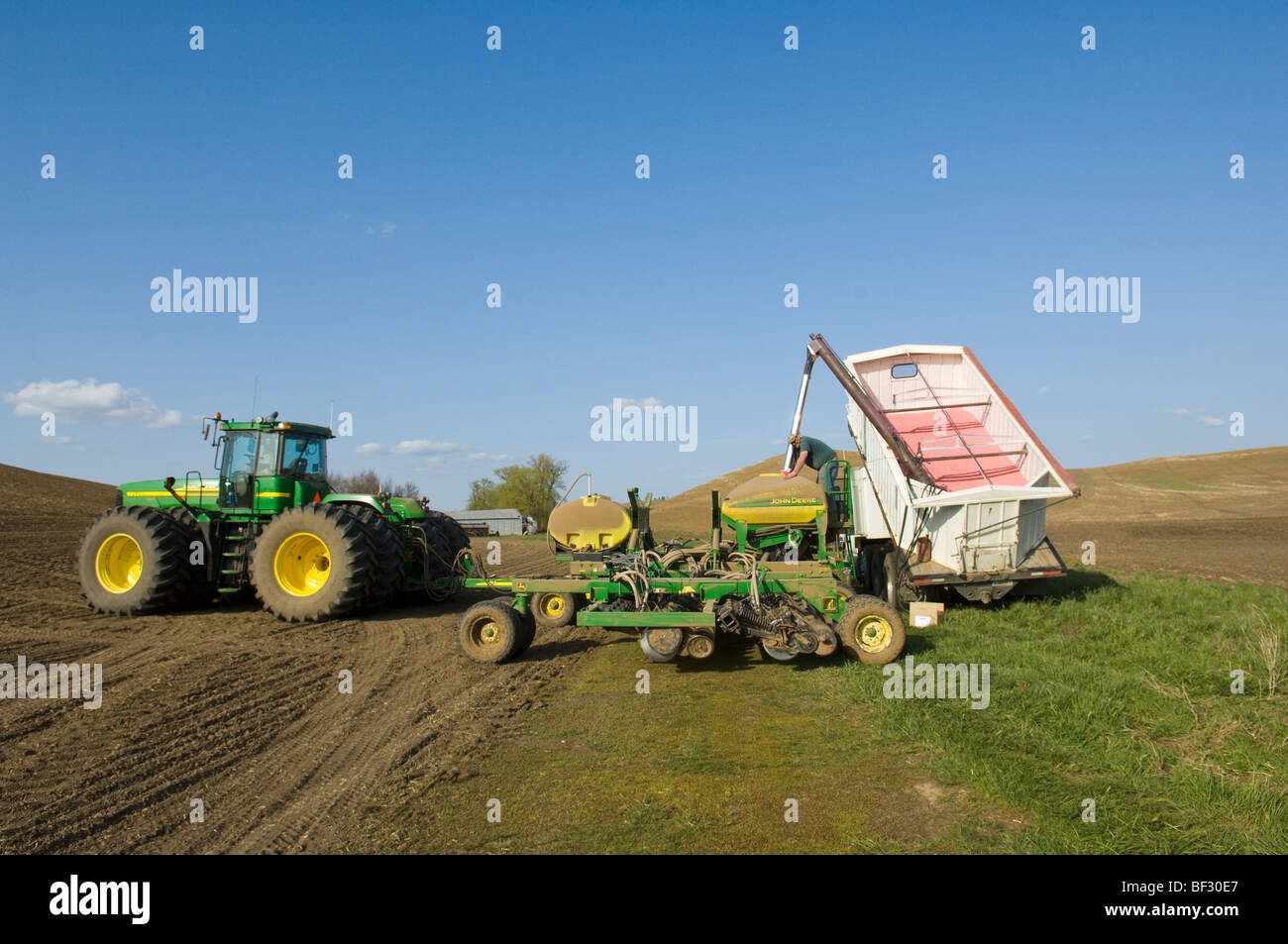 Loading an air seeder with garbanzo bean (chick pea) seeds during