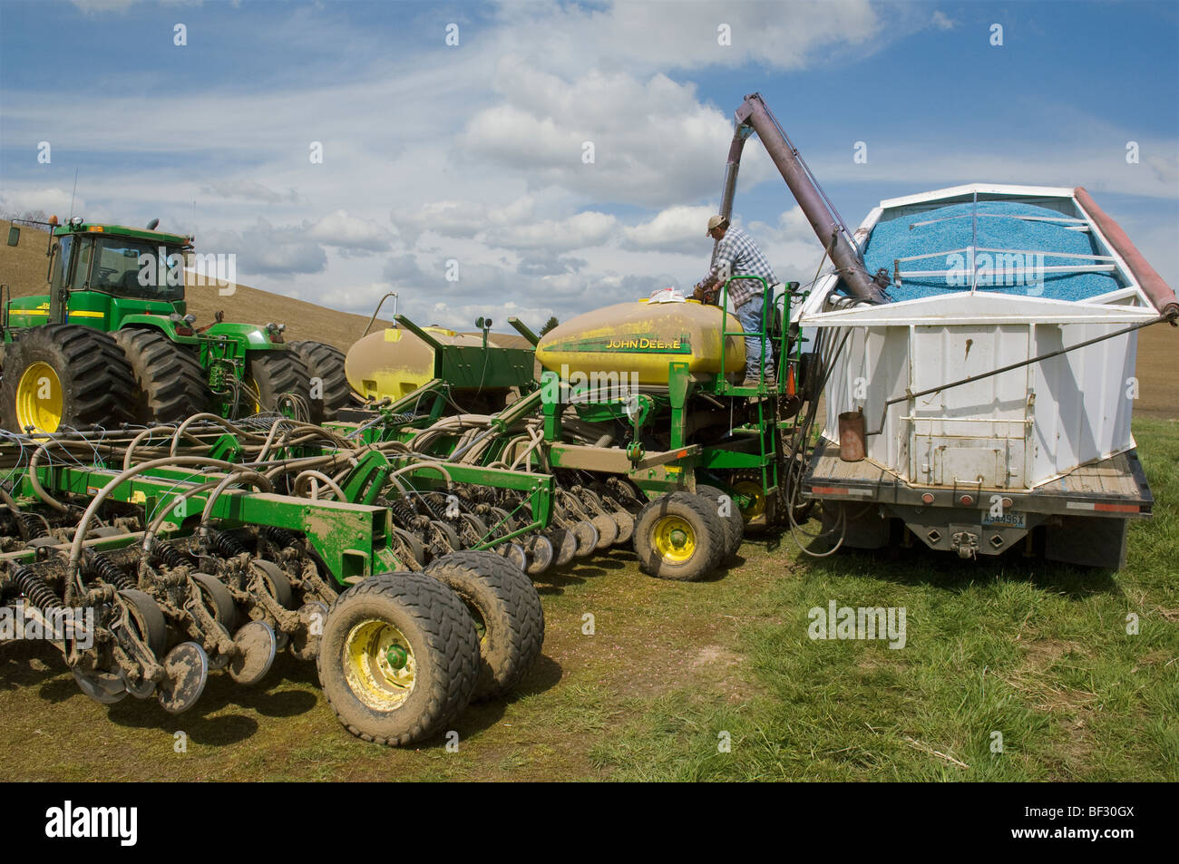 Loading an air seeder with garbanzo bean (chick pea) seeds during planting operations in the rolling hills of the Palouse / USA. Stock Photo