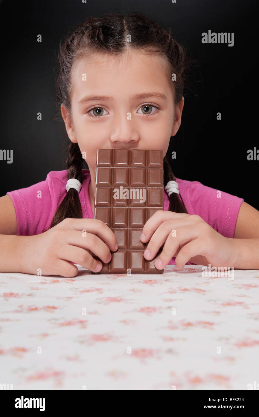 Girl holding a bar of chocolate Stock Photo - Alamy