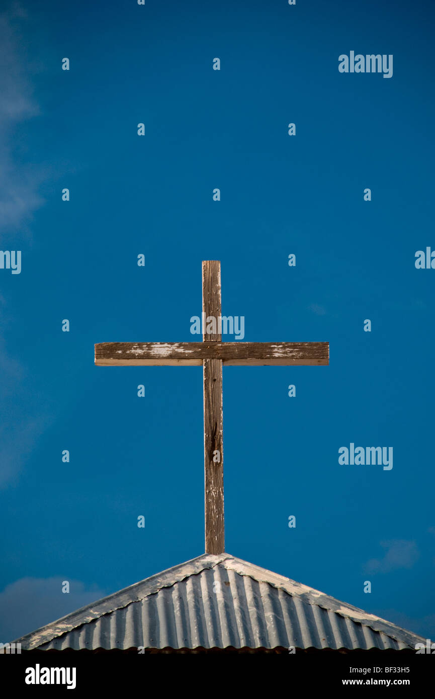 A cross atop 'La Divina Providencia' church near Manzano, New Mexico reflects the religious devotion of the Luceros family. Stock Photo