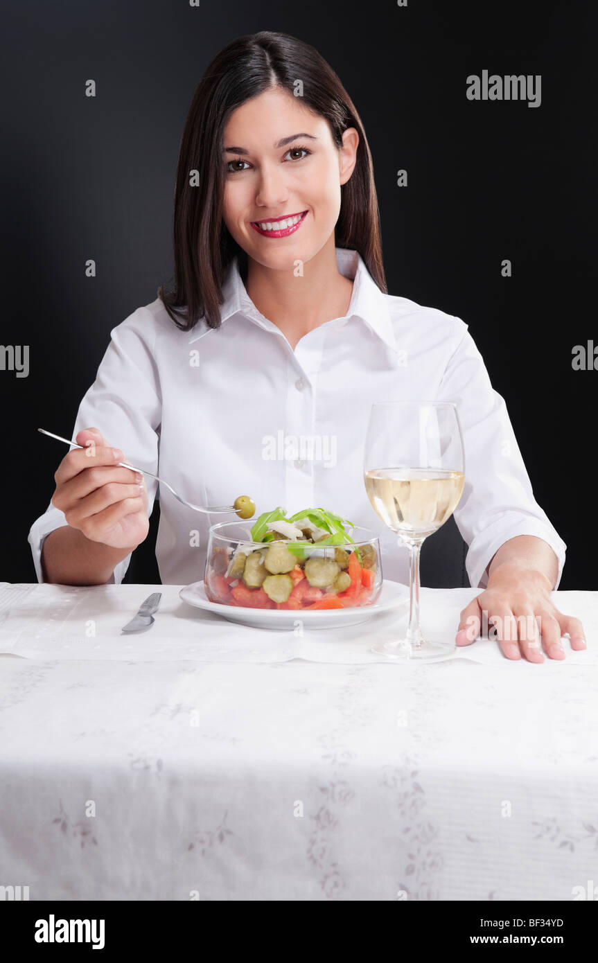 Woman eating salad and smiling Stock Photo