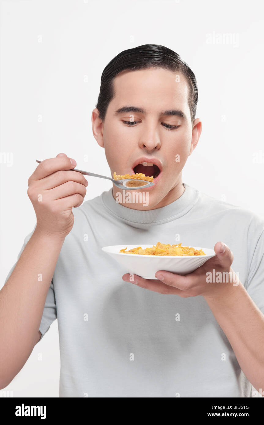 Man eating corn flakes Stock Photo Alamy