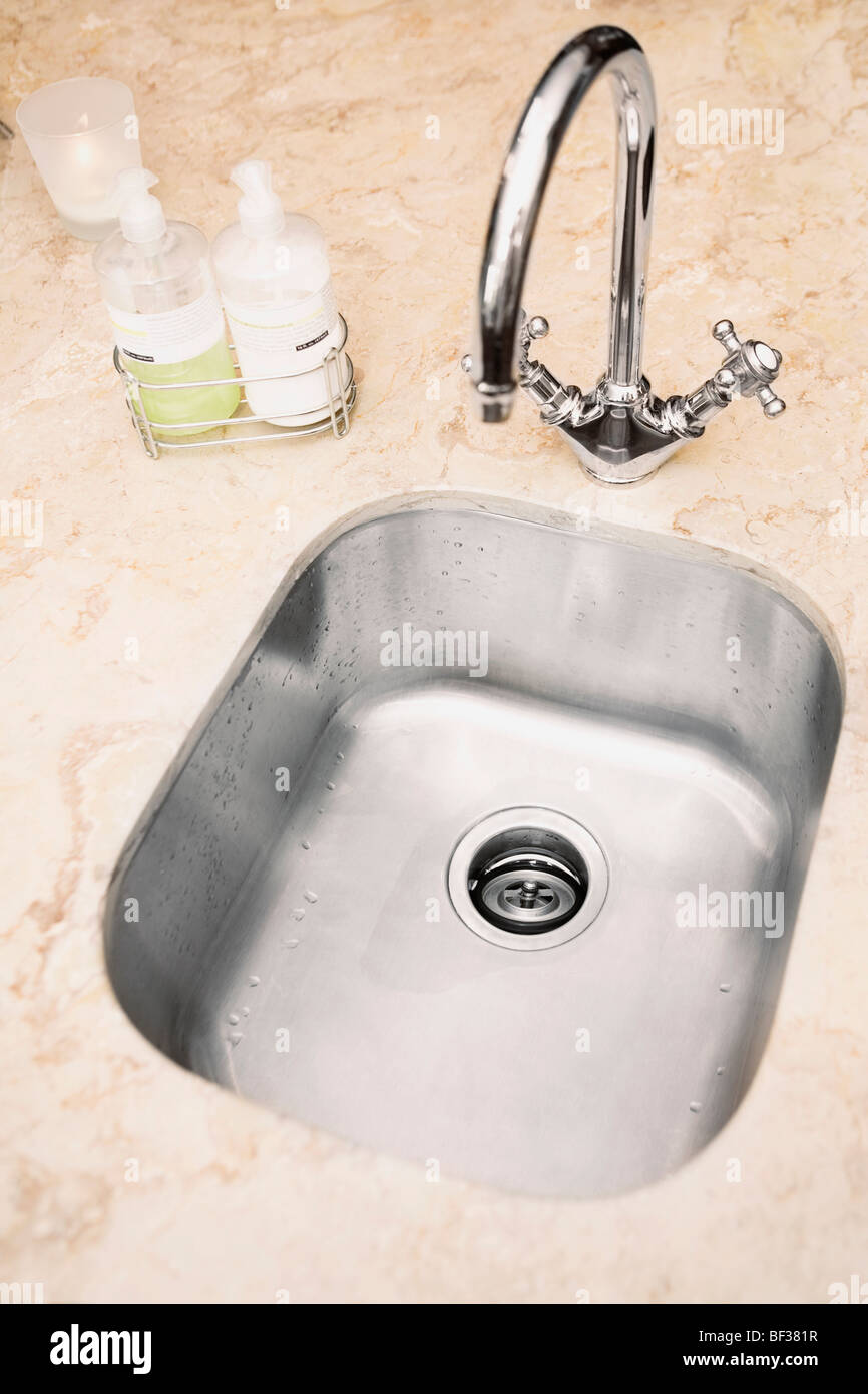 Stainless steel sink with arched tap Stock Photo