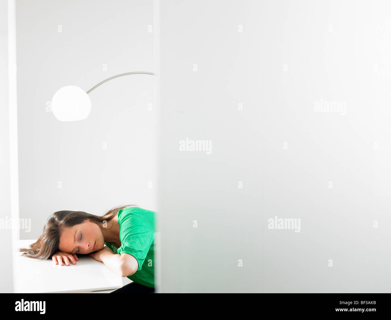 Woman sleeping on her desk Stock Photo