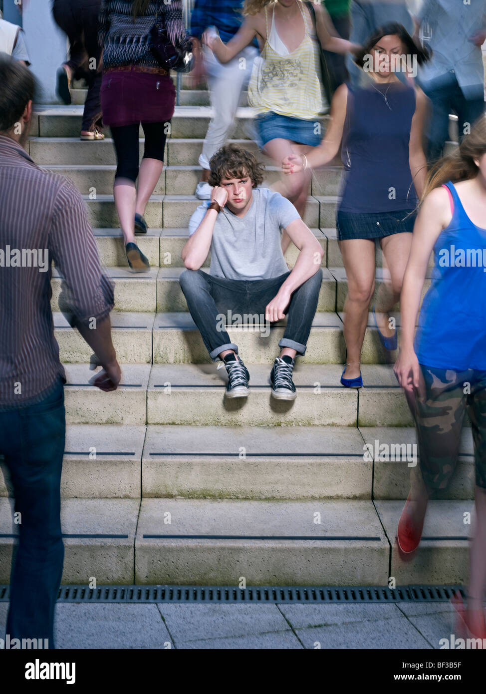 Portrait of lone young man in crowd Stock Photo