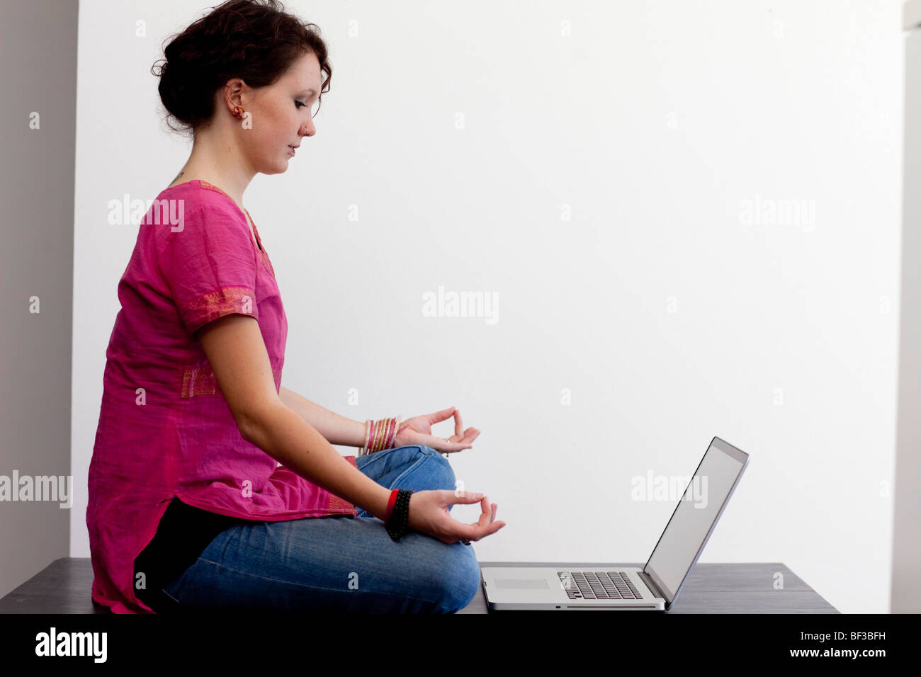 Meditation in front of a notebook Stock Photo