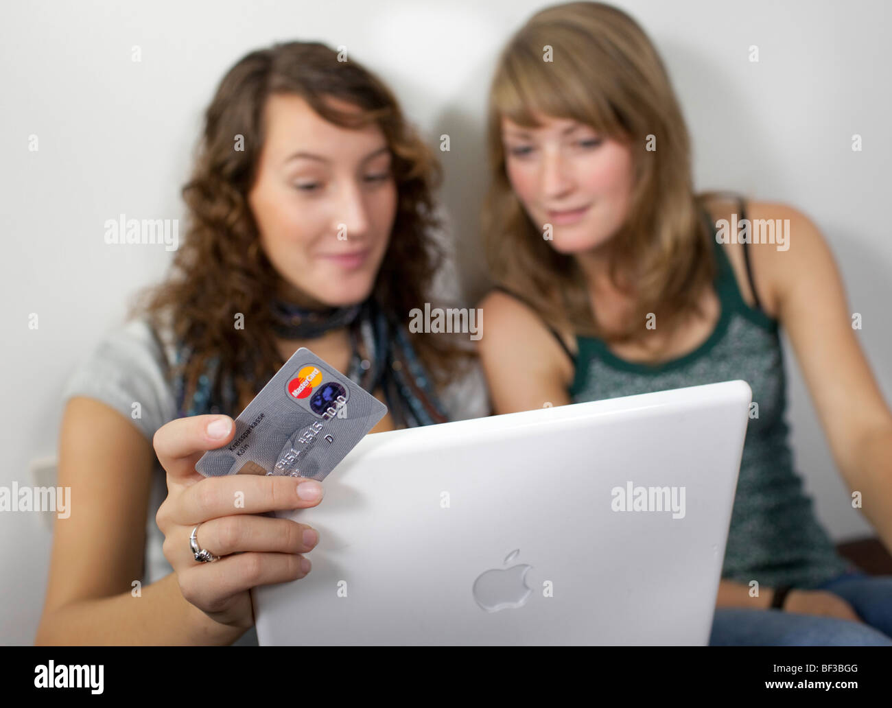 Friends shopping online together. Stock Photo