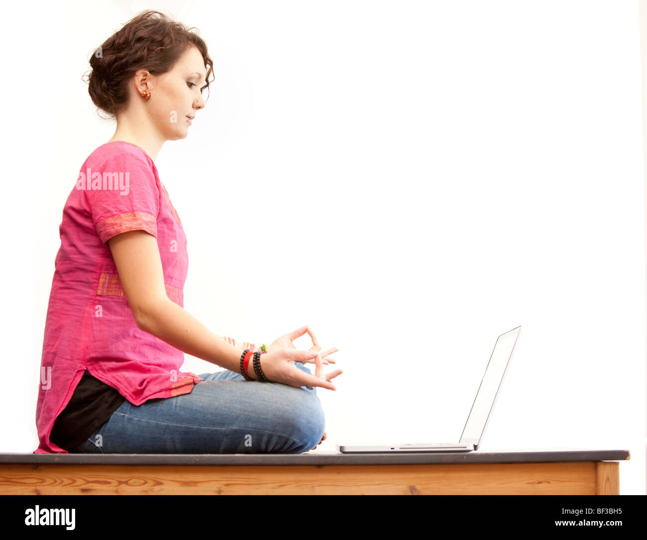 Meditation in front of a notebook Stock Photo