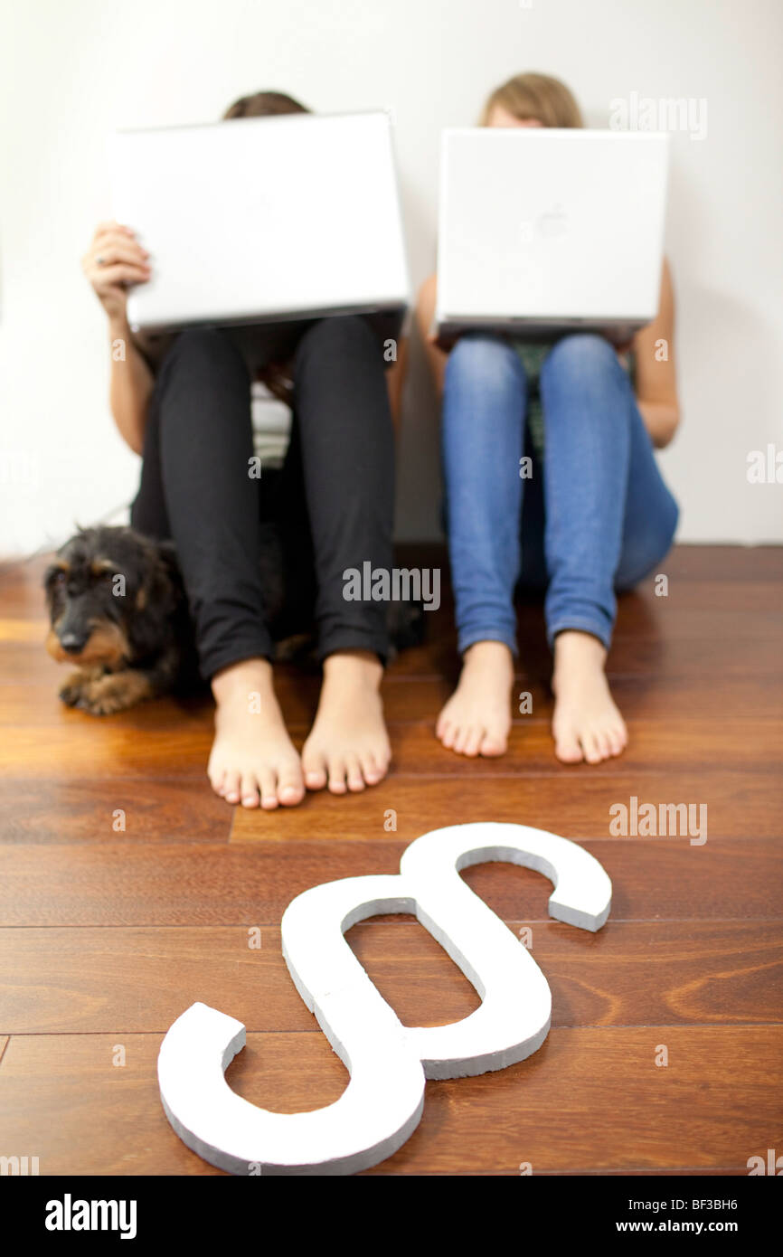 Friends sitting on the floor with notebooks . | Stock Photo