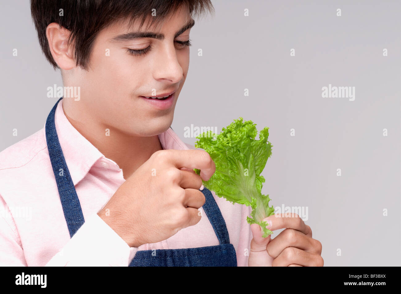 Close-up of a man holding a lettuce leaf Stock Photo