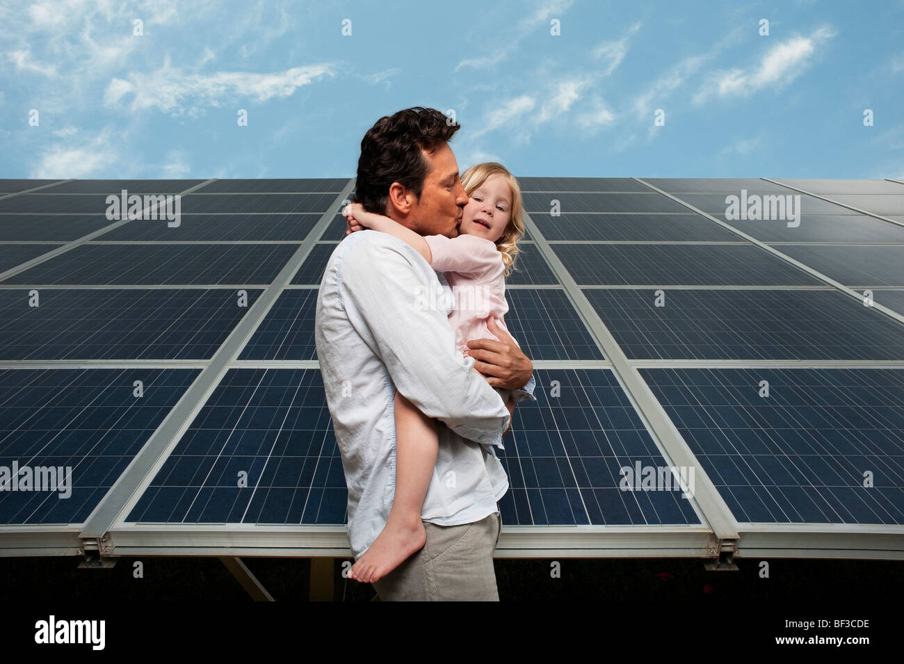 Man and daugther in front of solar panel Stock Photo