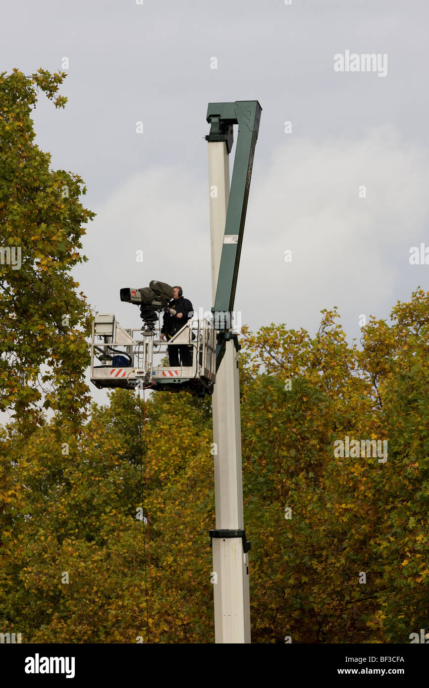 A television outside broadcast cameraman working from the top of a crane lift in London Stock Photo