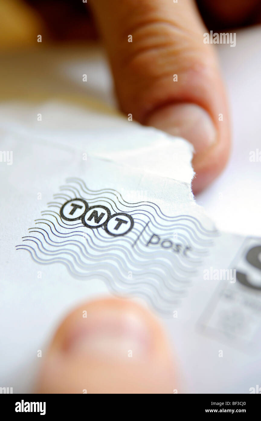 A man opens a letter delivered by TNT Stock Photo