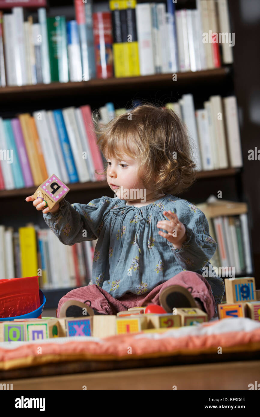 Girl playing with toys Stock Photo - Alamy