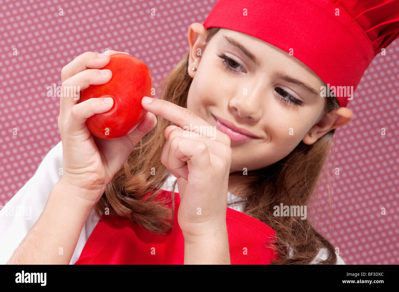 Girl holding a tomato Stock Photo - Alamy