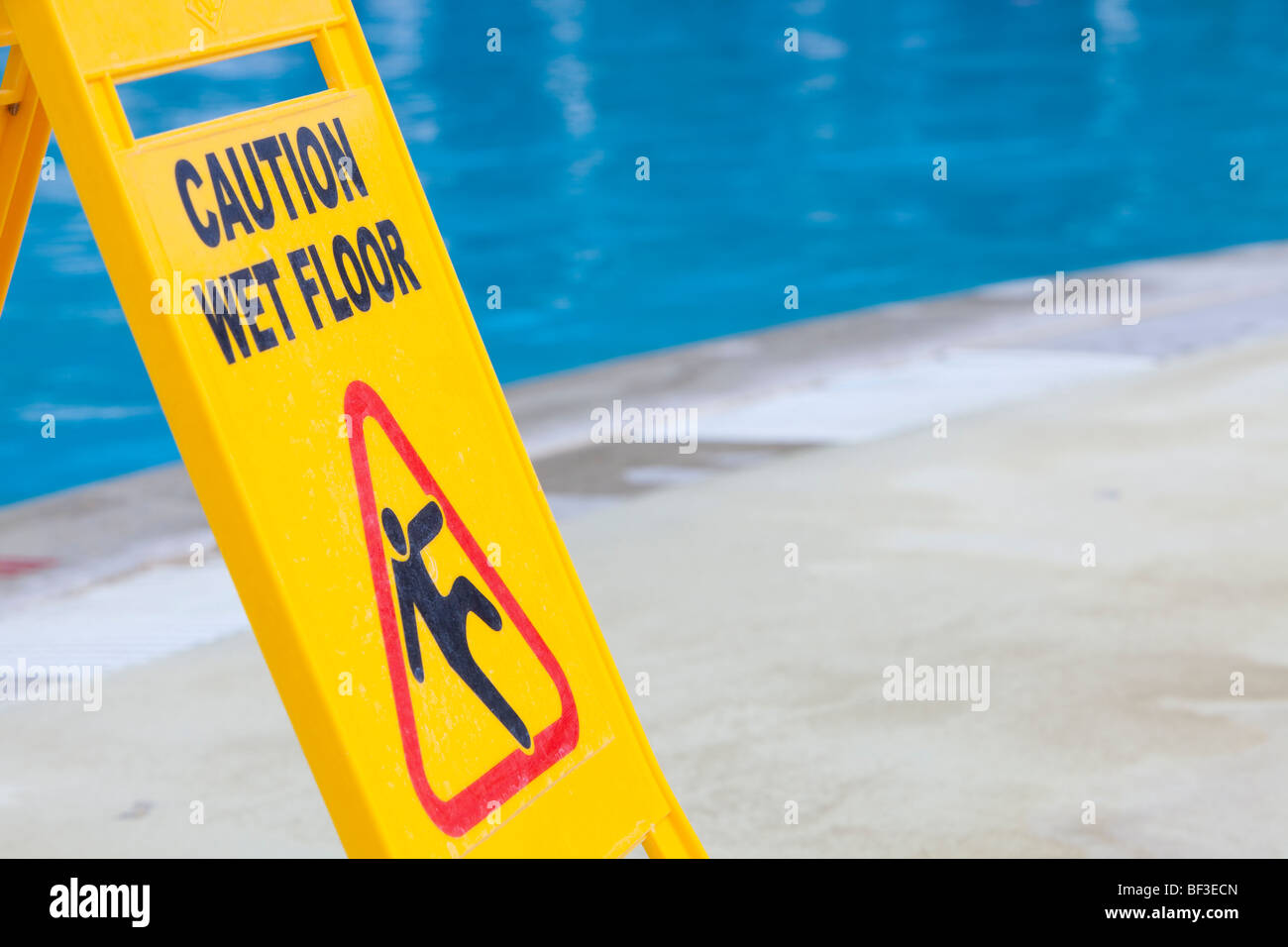 A caution sign on the edge of a swimming pool Stock Photo