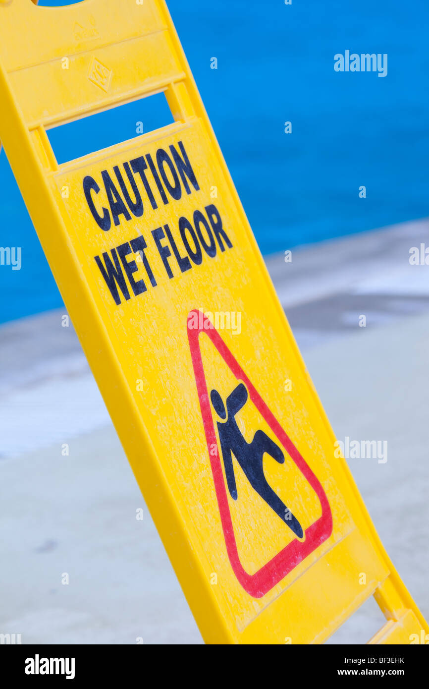 A caution sign on the edge of a swimming pool Stock Photo