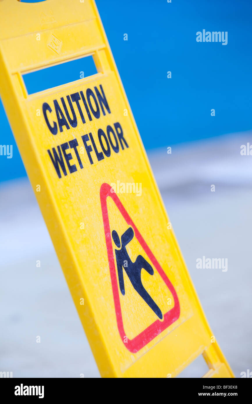 A caution sign on the edge of a swimming pool Stock Photo