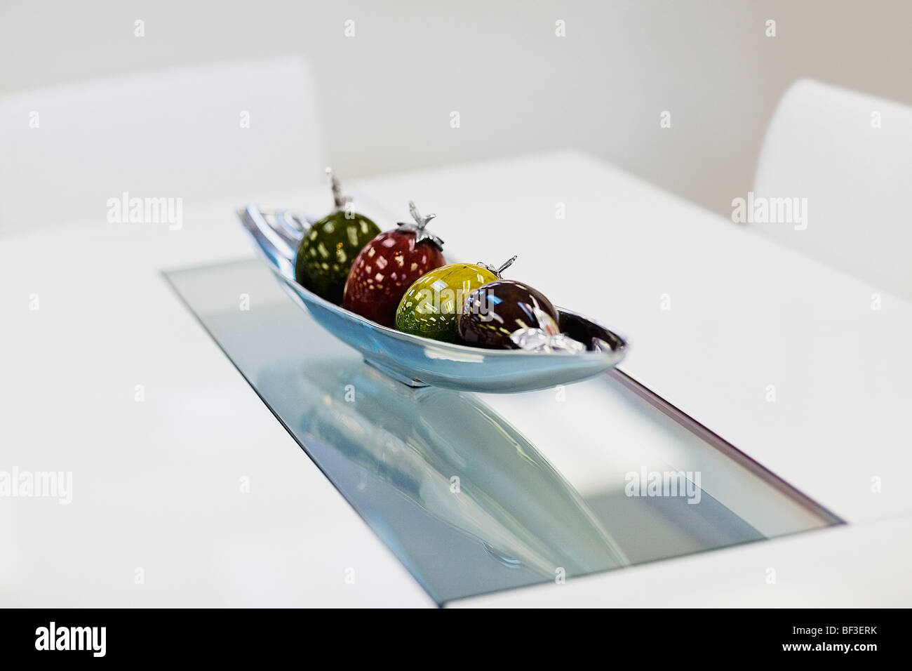 Artificial fruits in a bowl on a dining table Stock Photo Alamy