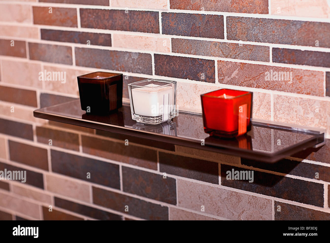 Colorful candles on a shelf in the bathroom Stock Photo Alamy